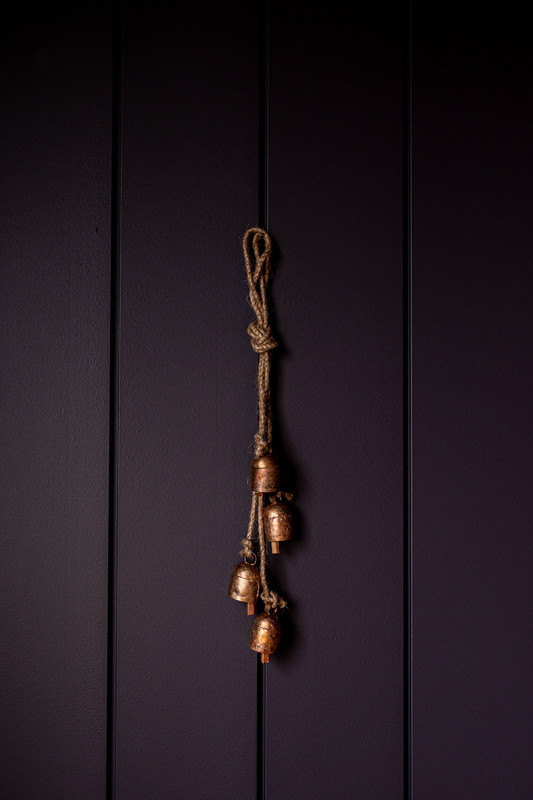Small iron bell hanging clusters by Luxe B Co, showcasing multiple elegant bell-shaped ornaments with intricate details.