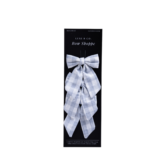 Baby blue gingham fabric bows with clips set by Luxe B Co, featuring small, adorable hair accessories for babies and toddlers.