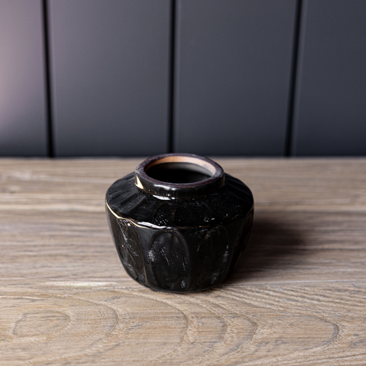 Small black ceramic vase by Luxe B Co with a sleek, modern design suitable for home decor or floral arrangements.