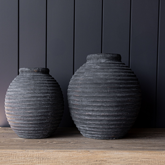 Black terracotta line vase by Luxe B Co featuring a sleek, modern design with a smooth black finish and subtle textured details.