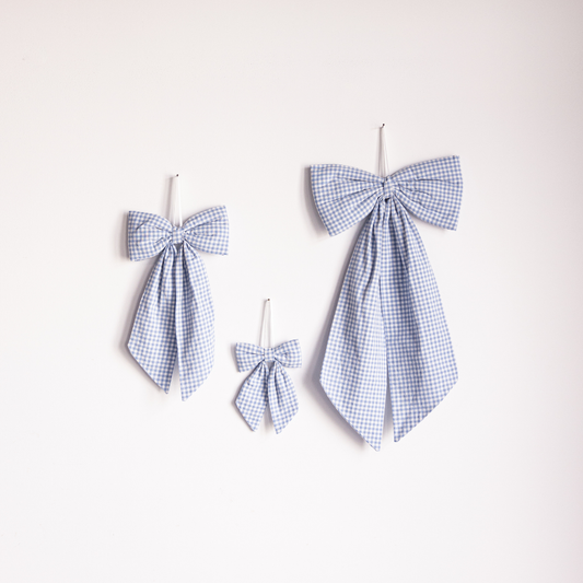 Blue mini gingham fabric bows by Luxe B Co, small decorative hair accessories with a classic checkered pattern.