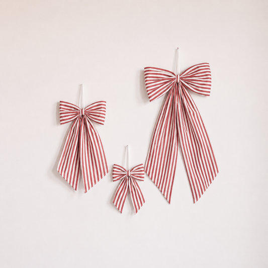Red fabric candy cane bows from Luxe B Co, featuring festive holiday-themed bows with a classic candy cane design.