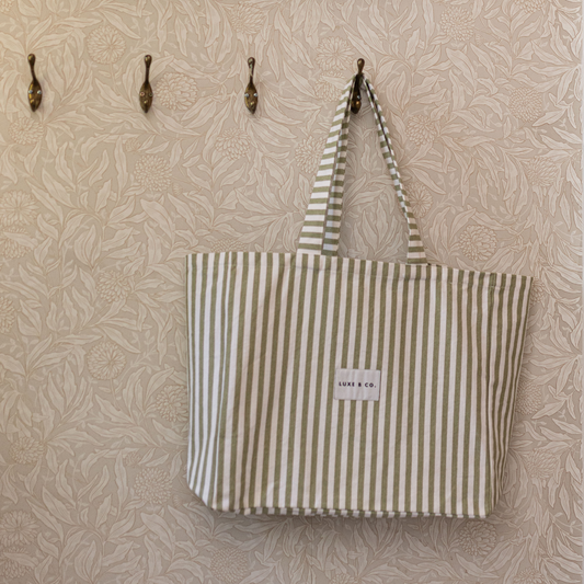 Green striped tote bag by Luxe B Co with sturdy handles and spacious interior, perfect for everyday use.