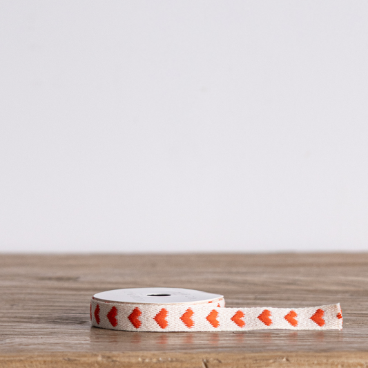 Orange hearts woven ribbon by Luxe B Co, featuring a vibrant pattern of orange hearts on a woven ribbon background.