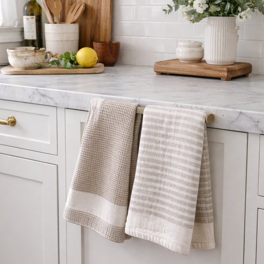 Kitchen with marble countertop, wooden cutting board, and potted plants.