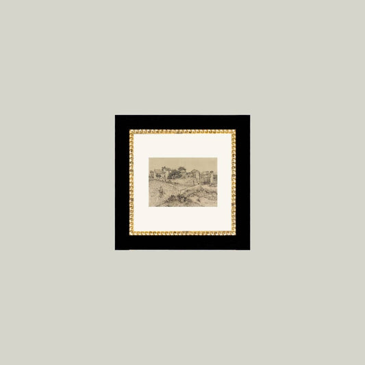 Framed antique-inspired art of a Tuscan village scene by Luxe B Co, showcasing warm tones and detailed landscape artwork.