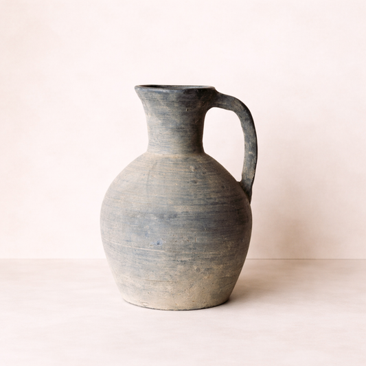 Stoneware pitcher on a light beige background