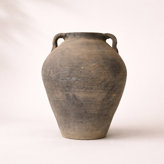 Vintage terracotta jar with handles on a white background
