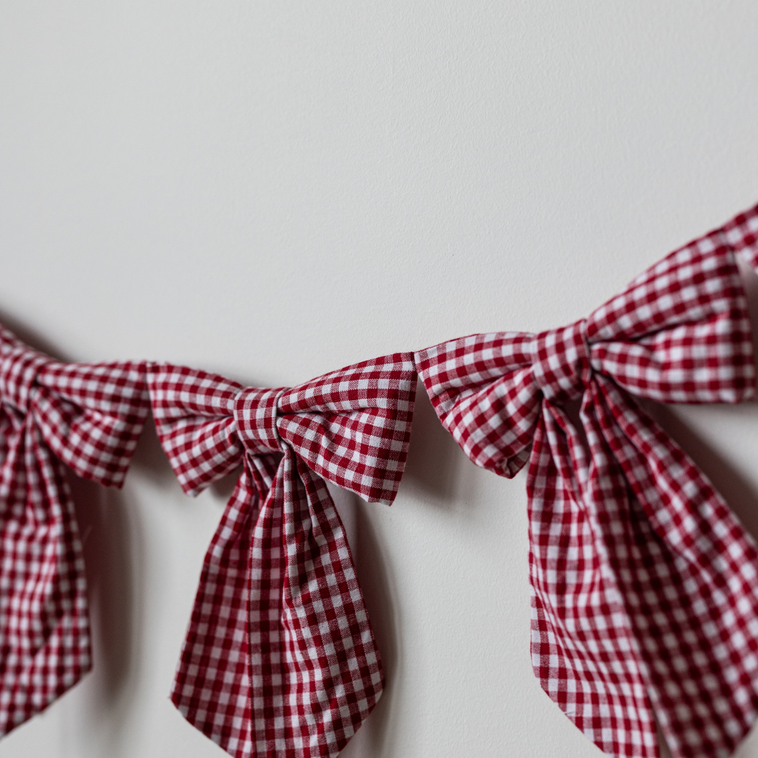 Red gingham fabric bow garland featuring multiple bows, perfect for decorating, by Luxe B Co.
