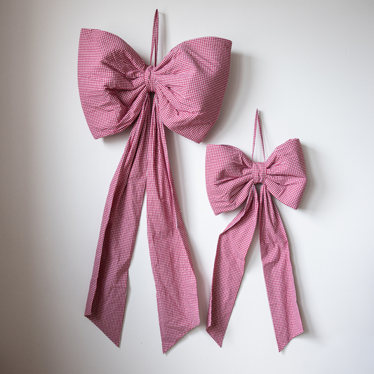 Luxe B Co oversized red gingham bow, large fabric accessory with a classic checkered pattern and tied bow design.