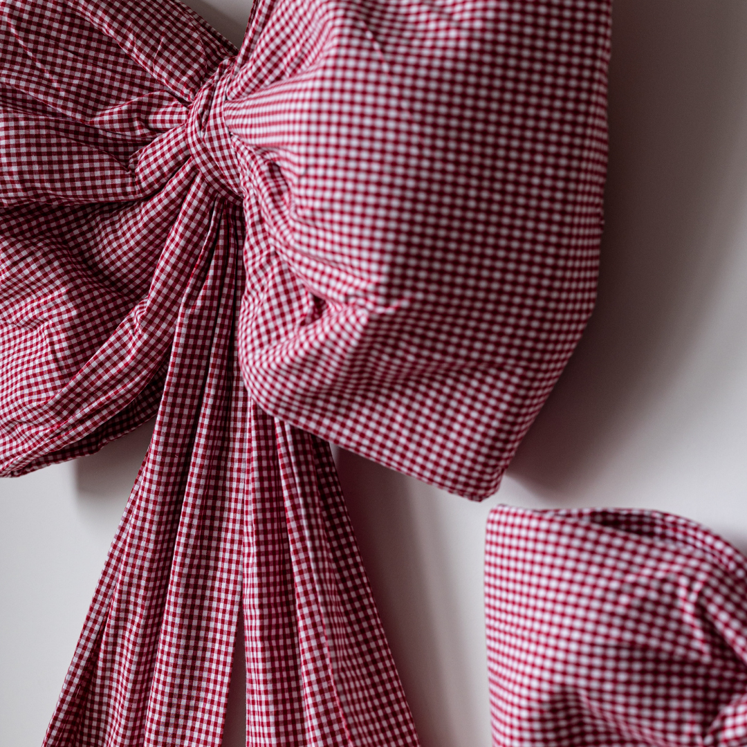 Large red gingham bow from Luxe B Co featuring oversized design and classic bow shape, perfect for accessories or decorations.