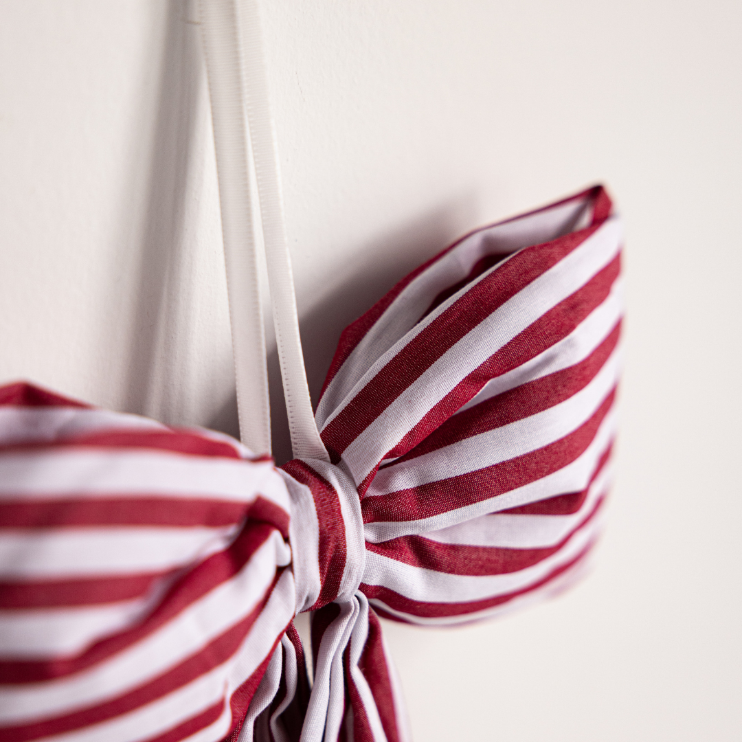 Red fabric candy cane bows by Luxe B Co, featuring festive Christmas-themed decorative bows with candy cane patterns.