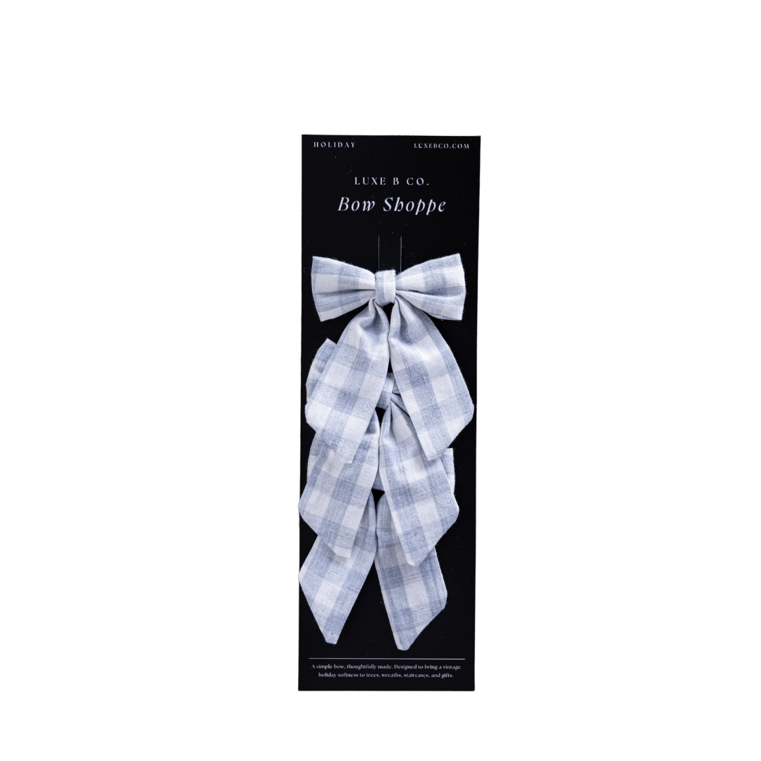 Baby blue gingham fabric bows with clips set by Luxe B Co, featuring small, adorable hair accessories for babies and toddlers.