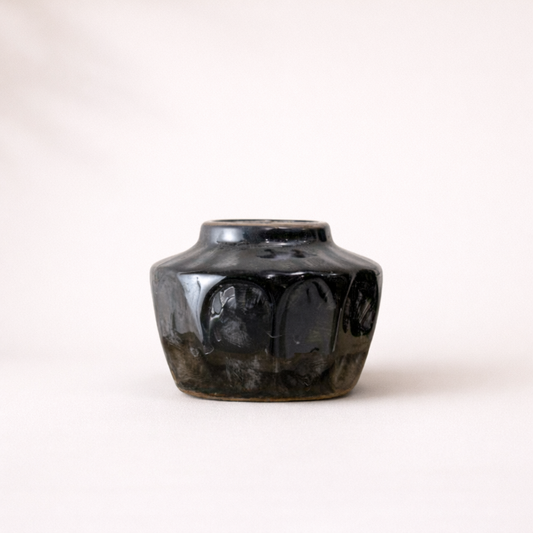 Black ceramic vase on a white background