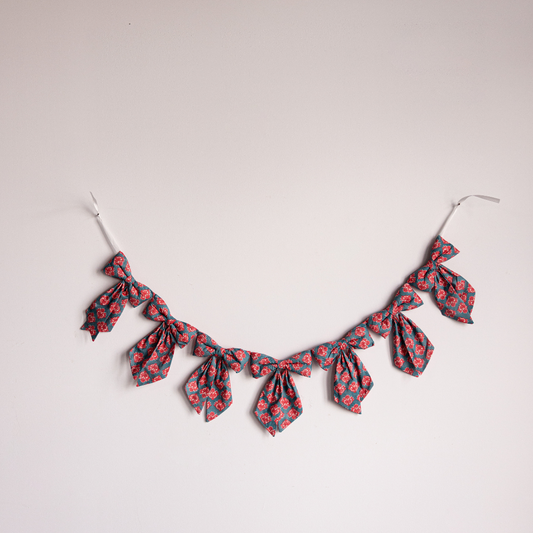 Blue and coral floral block print fabric bows on a garland, decorative holiday decor by Luxe B Co.