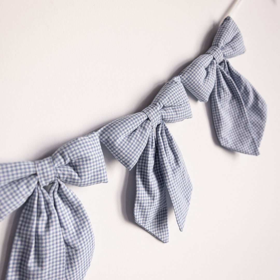 Blue mini gingham fabric bow garland featuring small fabric bows, perfect for decoration by Luxe B Co.