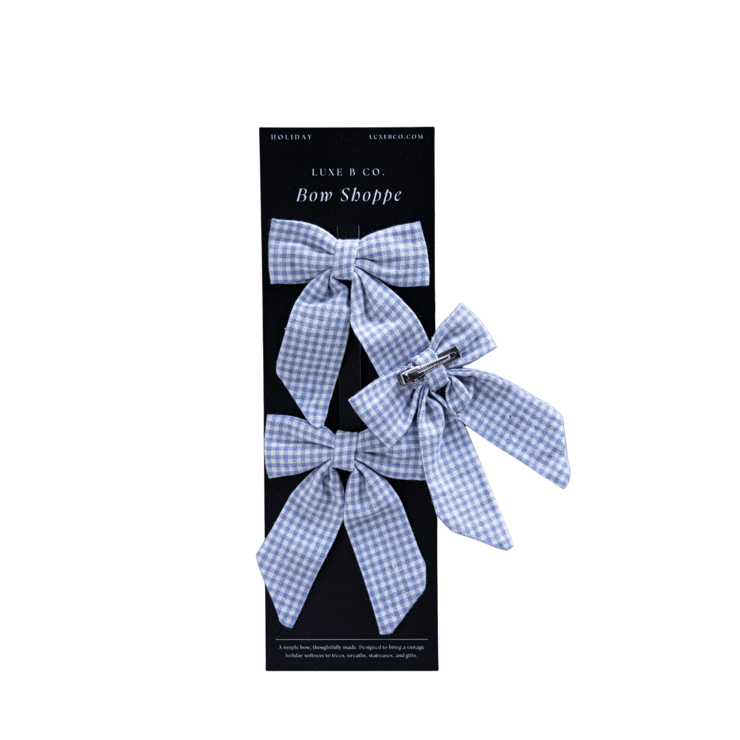Blue mini gingham fabric bows with clips set by Luxe B Co, featuring small, charming hair accessories with clip fastening.