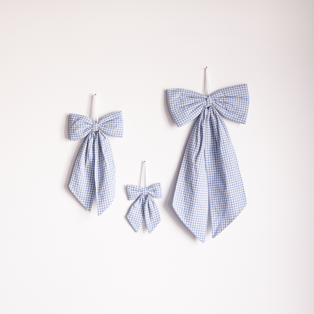 Blue mini gingham fabric bows by Luxe B Co, small decorative hair accessories with a classic checkered pattern.