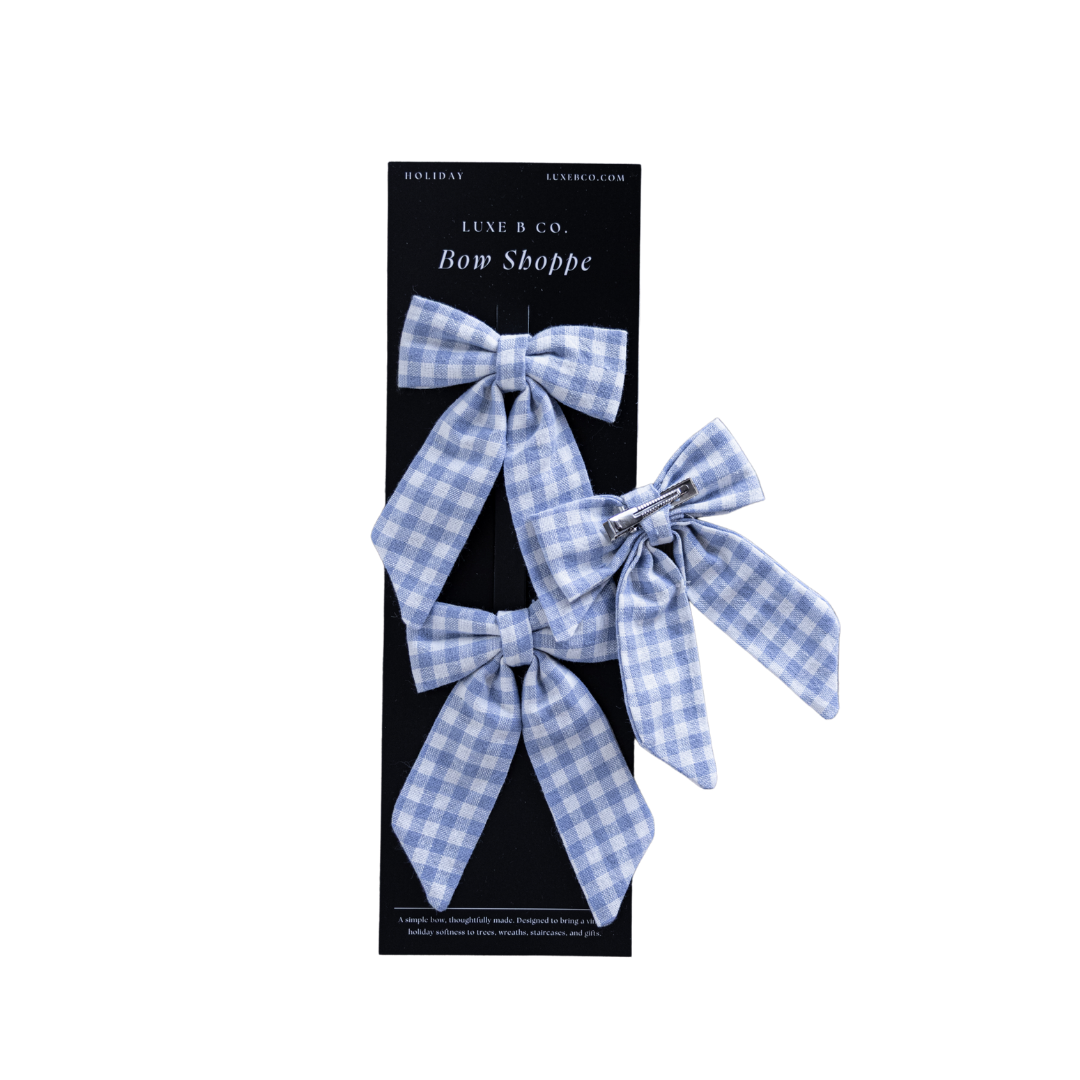 Set of blue small gingham fabric bows with clips by Luxe B Co, perfect for hair accessories or decorative embellishments.