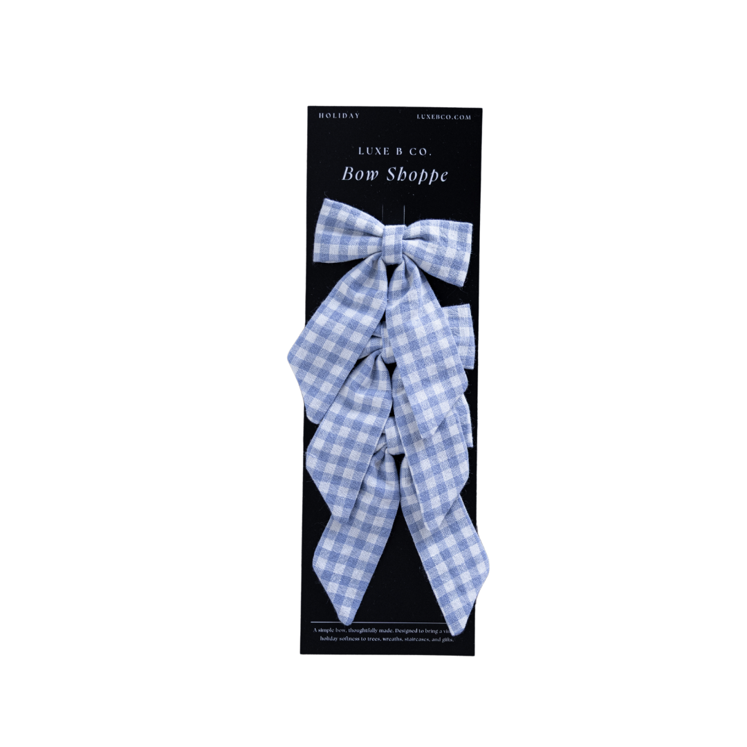 Set of blue small gingham mini fabric bows with clips from Luxe B Co, perfect for hair accessories and decorative use.