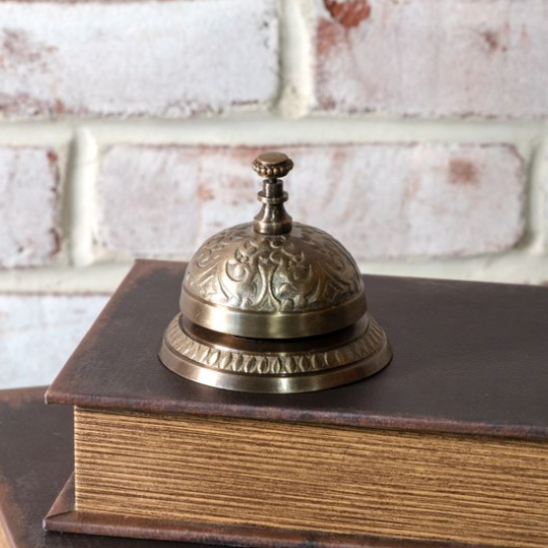 Decorative brass service bell by Luxe B Co with intricate design, ideal for vintage or classic decor accents.