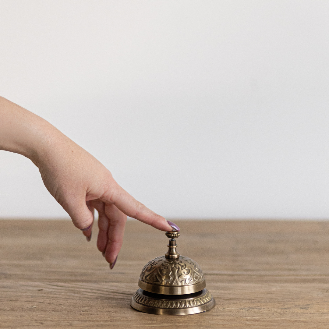 Decorative brass-inspired service bell by Luxe B Co, featuring a polished metal finish and classic design for tabletop display.