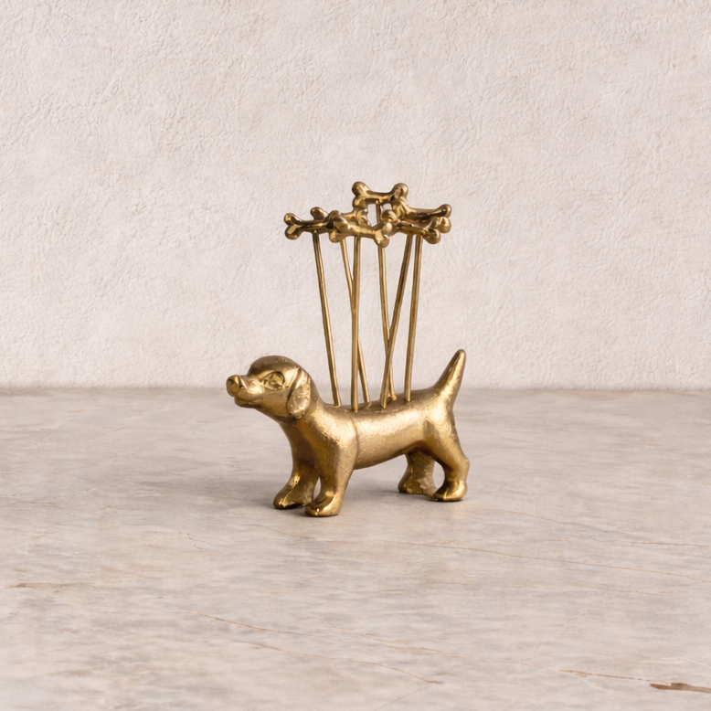 Brass dog-shaped holder with four small shelves on a wooden surface.