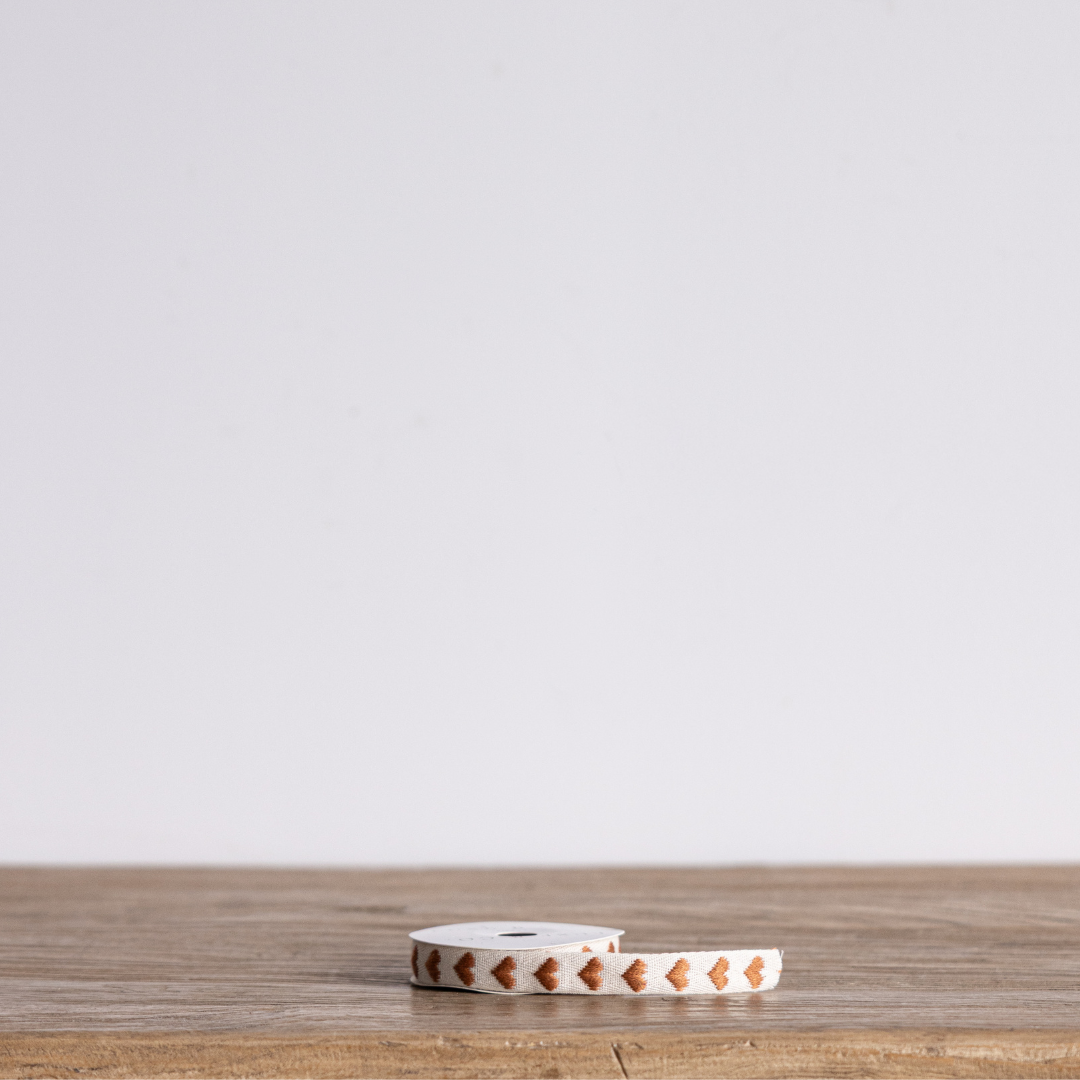 Brown hearts woven ribbon by Luxe B Co, featuring a textured design with a charming heart pattern, ideal for gift wrapping and crafts.