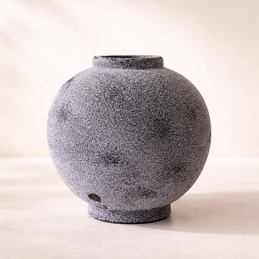 Textured gray ceramic vase on a light background