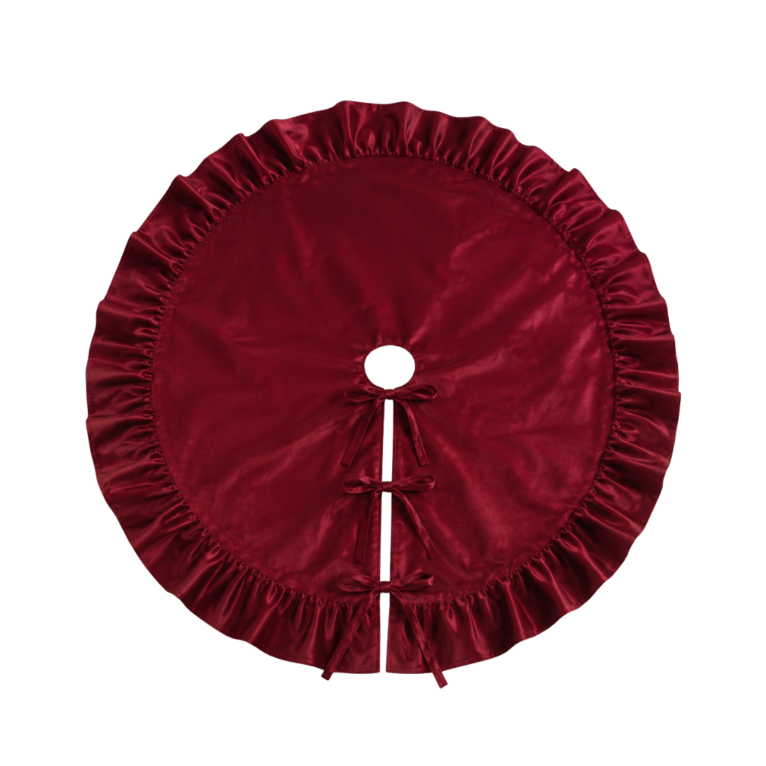 Deep red velvet tree skirt with ruffle trim from Luxe B Co., featuring a luxurious fabric and decorative ruffles for holiday decor.