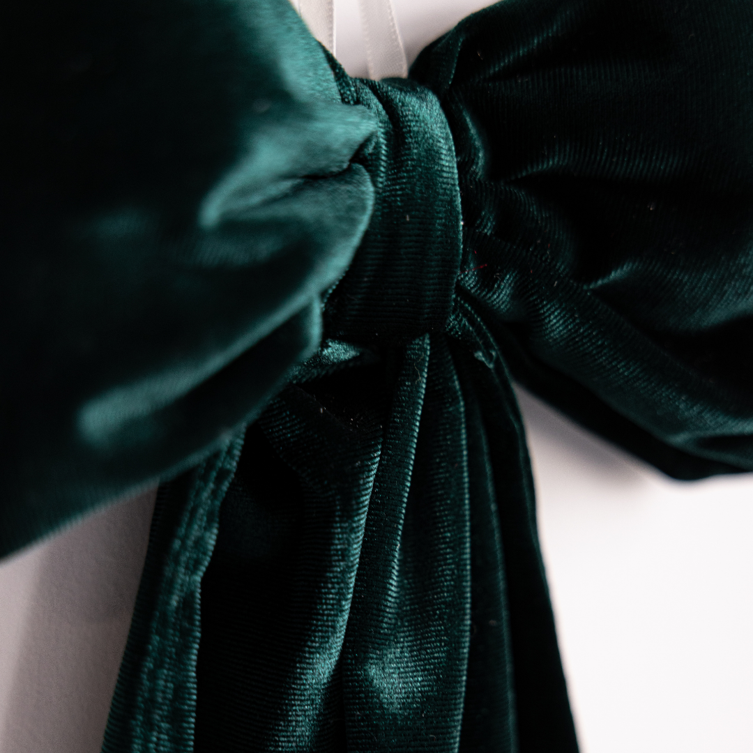 Emerald green velvet fabric bows by Luxe B Co with soft, plush texture and elegant design for accessories or decoration.