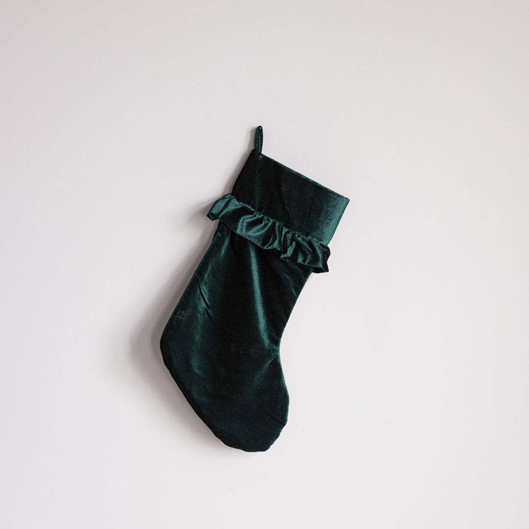 Emerald velvet holiday stocking by Luxe B Co with festive design and plush texture, perfect for Christmas decorations.