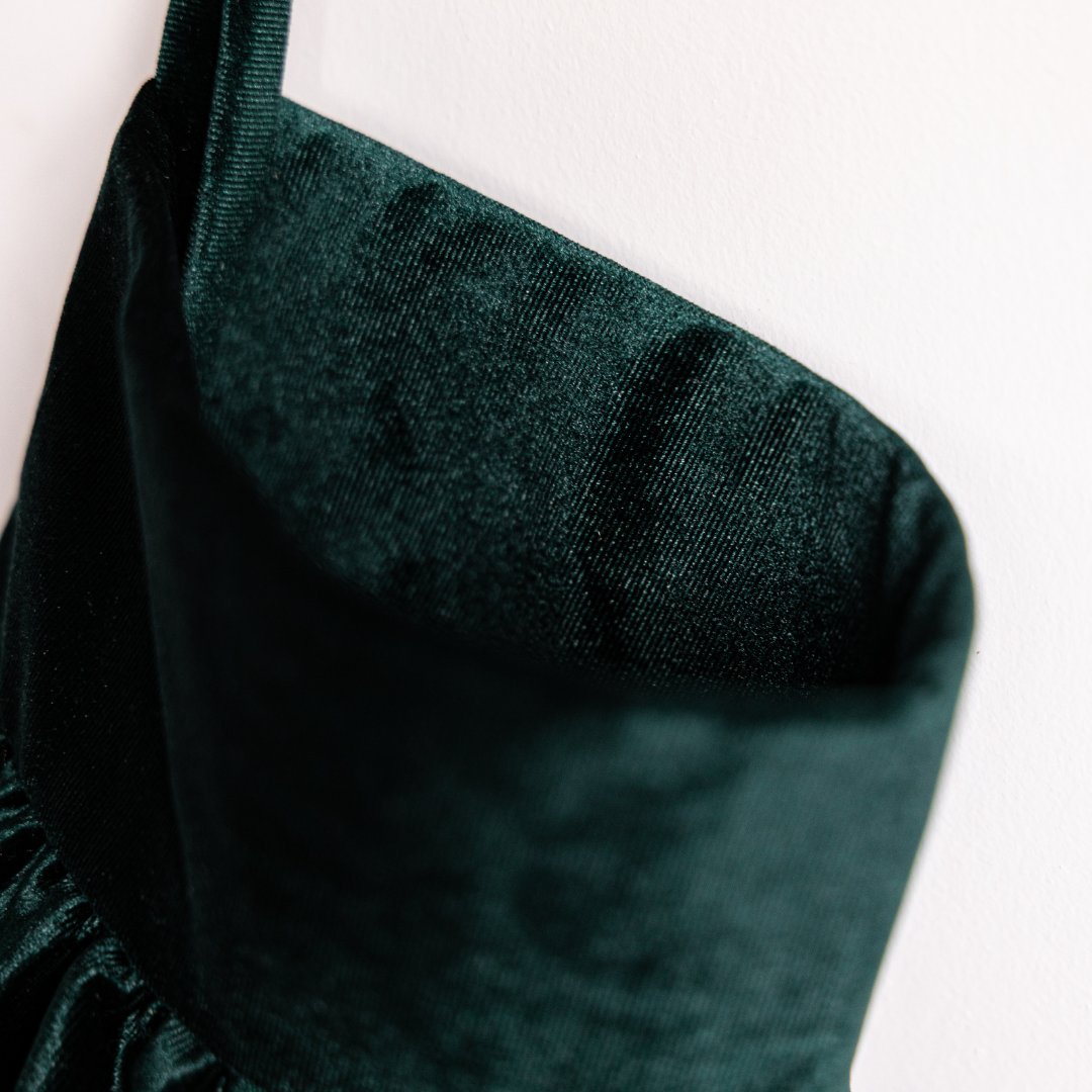 Emerald velvet holiday stocking by Luxe B Co with plush texture and decorative cuff, perfect for festive holiday decor.