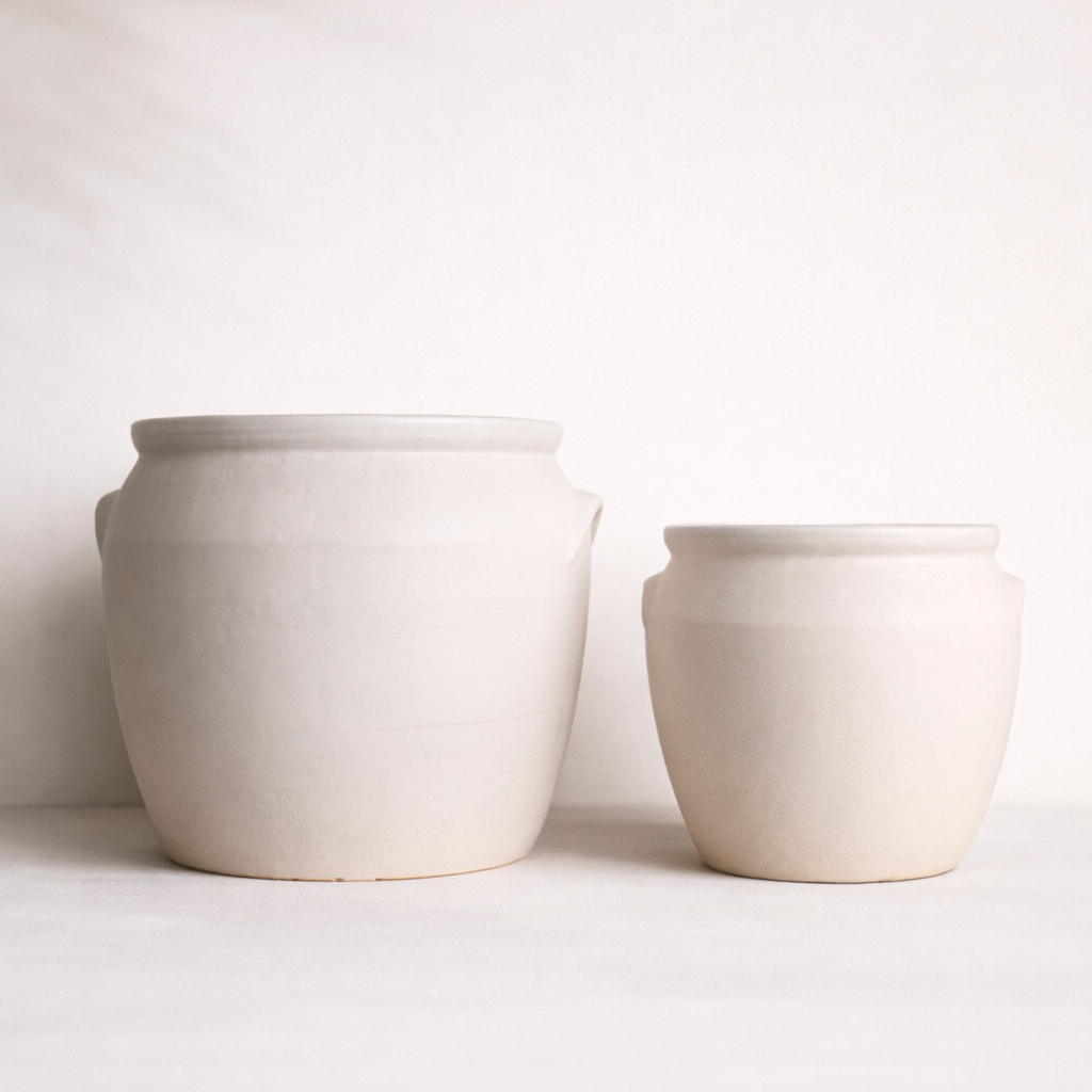 Two ceramic pots on a white background