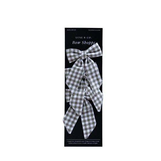 Set of small green gingham fabric bows with attached clips, perfect for hair accessories or decorative accents.