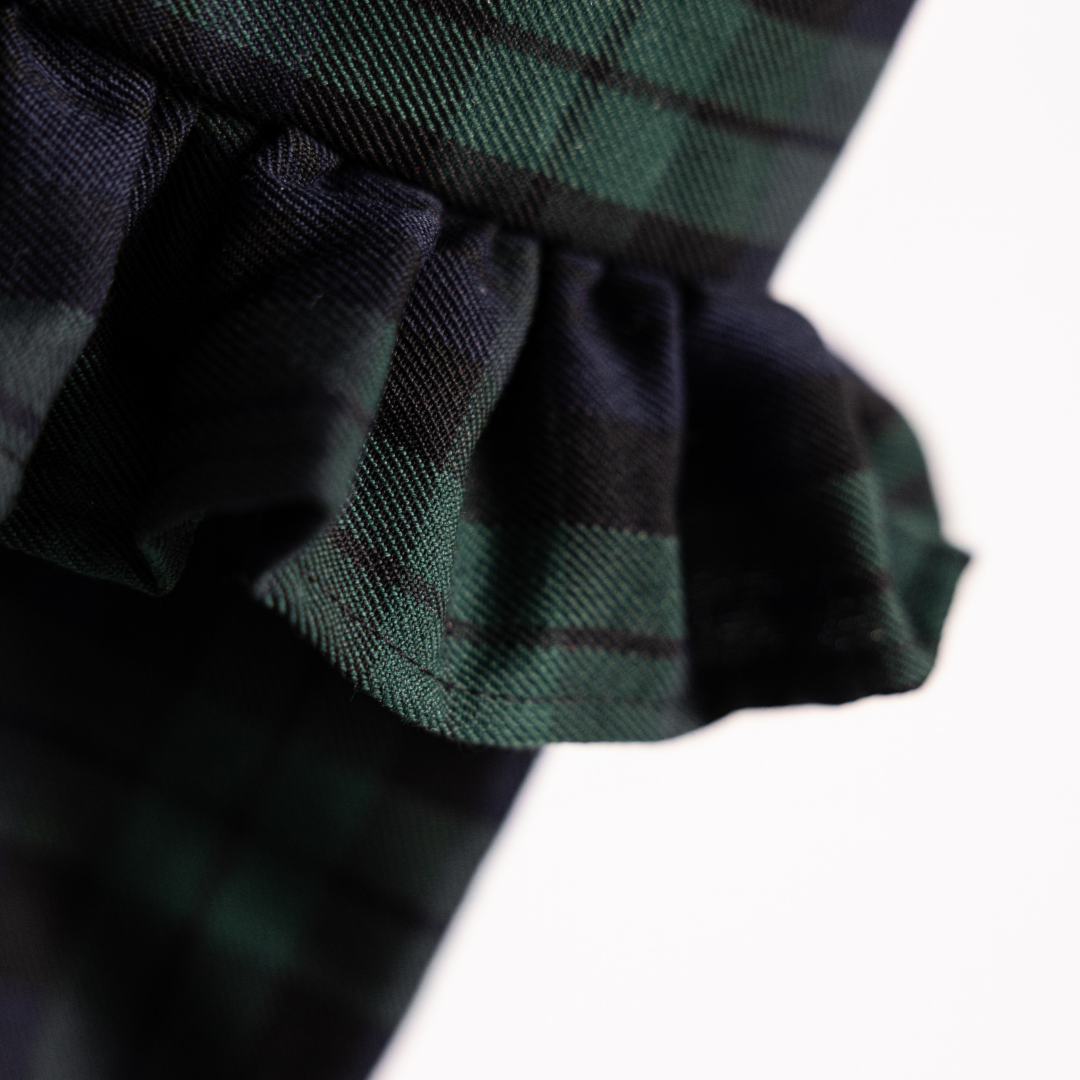 Green plaid holiday stocking by Luxe B Co with festive pattern and plush top, perfect for Christmas decoration.