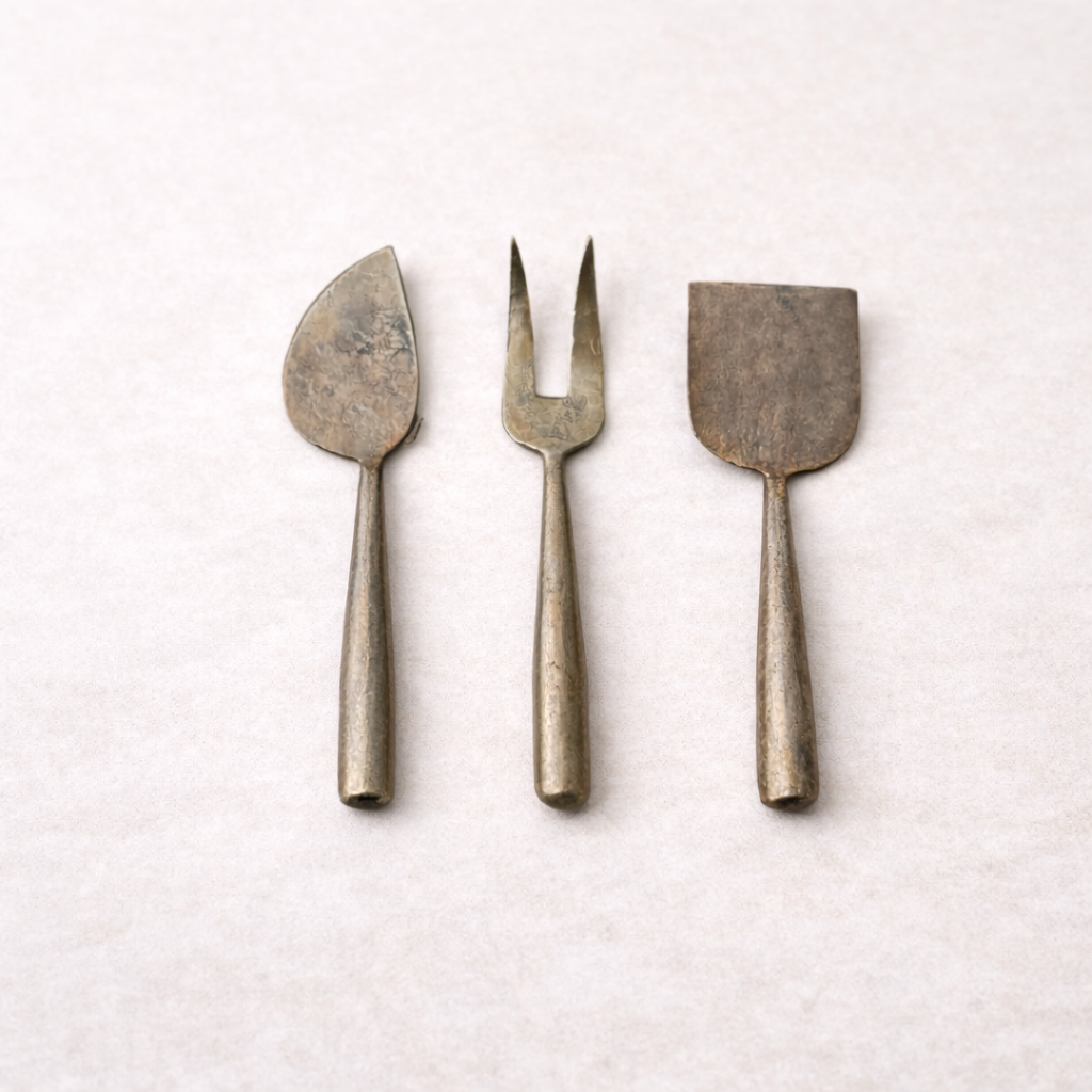 Set of three hand-forged metal cheese servers by Creative Co-op, featuring elegant serveware for cheese presentation.