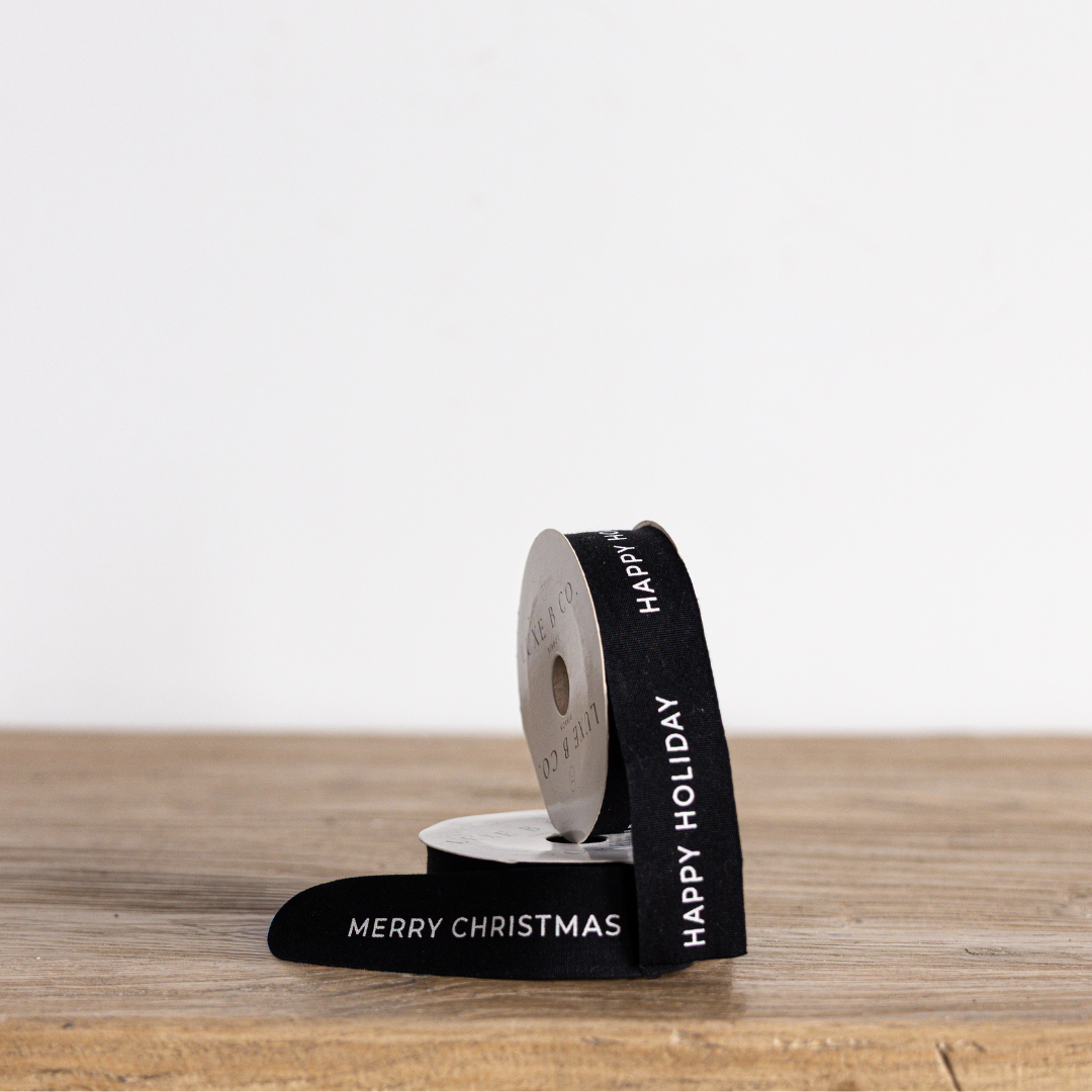 Black Christmas ribbon by Luxe B Co with festive holiday design, ideal for gift wrapping and holiday decorations.