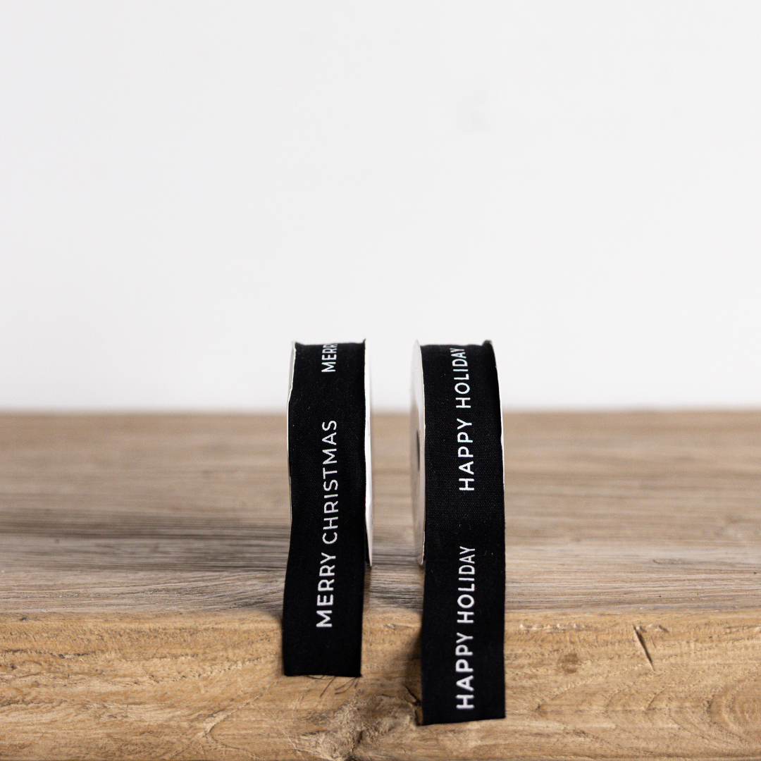 Black Merry Christmas ribbon by Luxe B Co featuring festive holiday design, perfect for gift wrapping and holiday decorations.