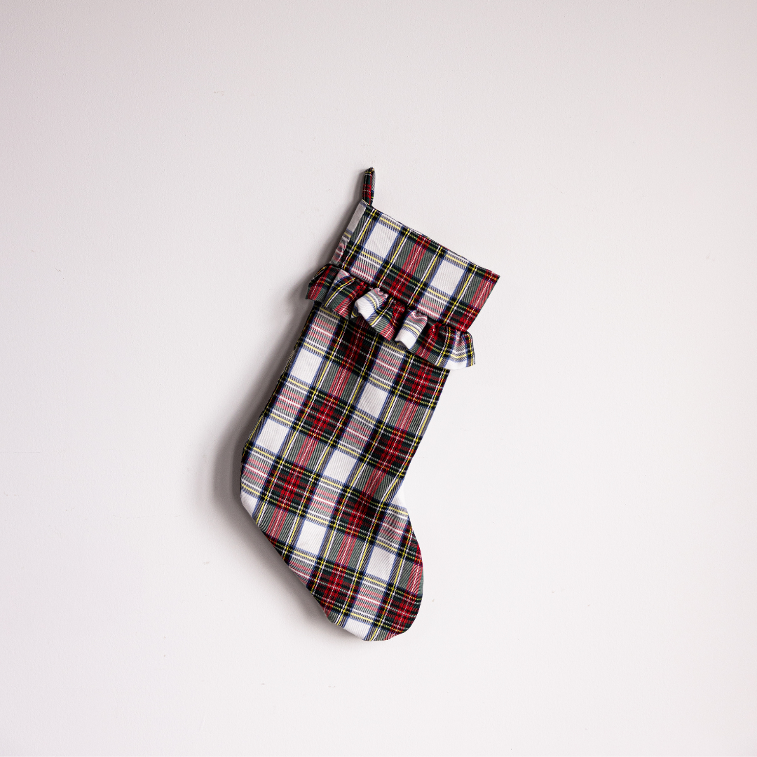 Luxe B Co plaid holiday stocking with festive red, green, and white tartan pattern for Christmas decor.