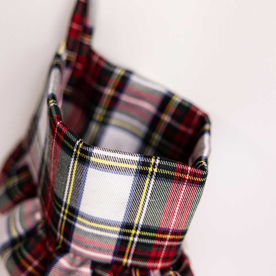 Red and green plaid holiday stocking by Luxe B Co with festive Christmas pattern and plush cuff for seasonal decorating.