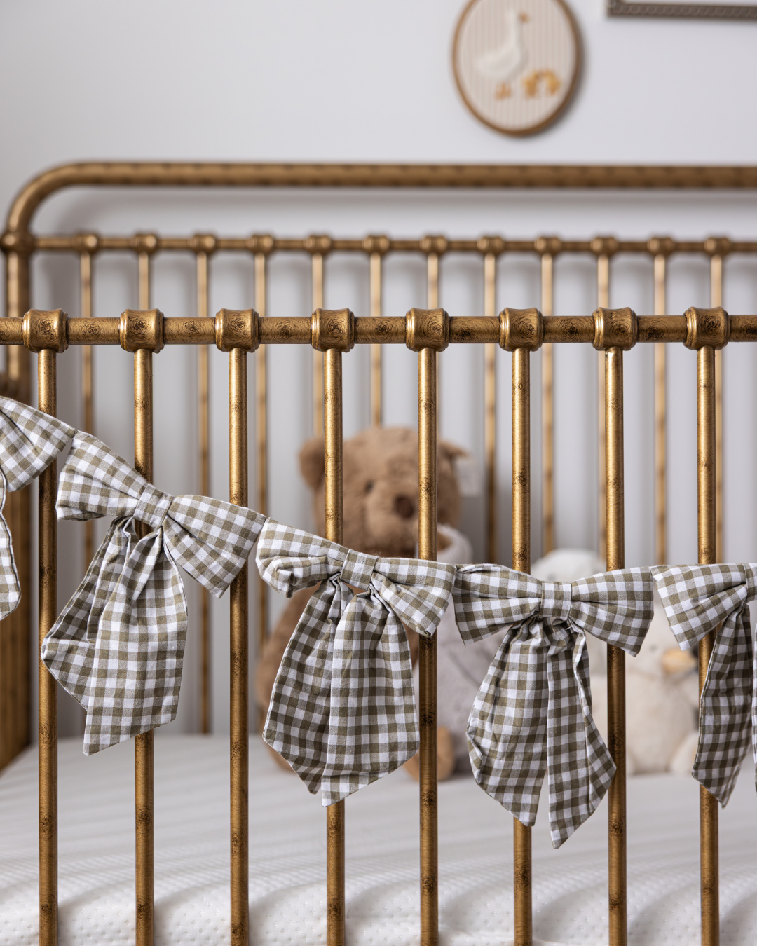 Green gingham bow garland with multiple decorative bows from Luxe B Co, perfect for festive or decorative occasions.