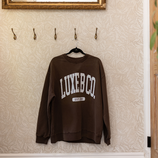 Brown Luxe B Co. sweater with a cozy pullover design, soft knit fabric, and classic fit, perfect for casual or layered looks.