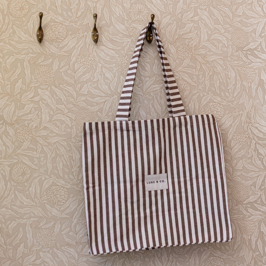 Luxe B Co. brown striped tote bag with sturdy handles and spacious interior, perfect for daily use and casual outings.