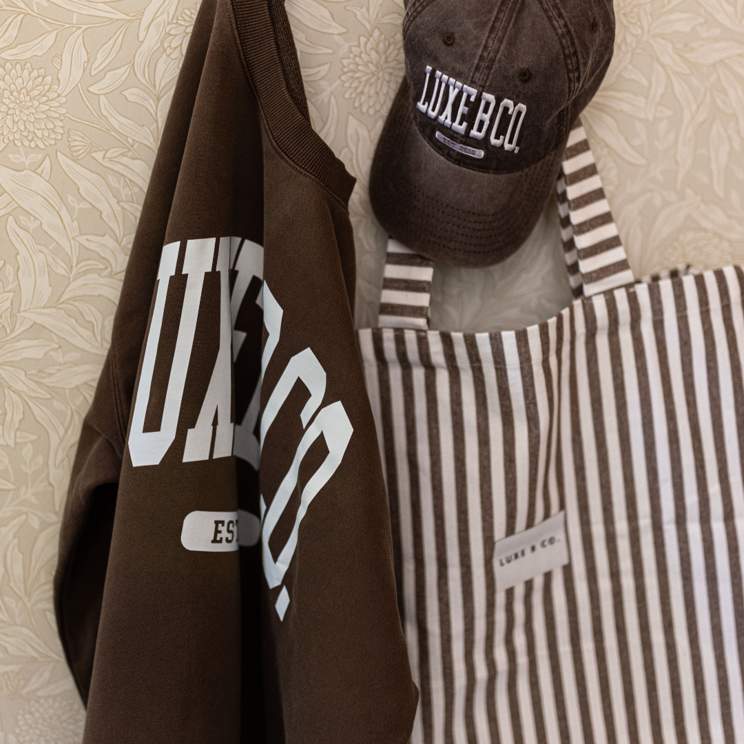 Luxe B Co. brown striped tote bag with sturdy handles and spacious interior, perfect for everyday carrying.