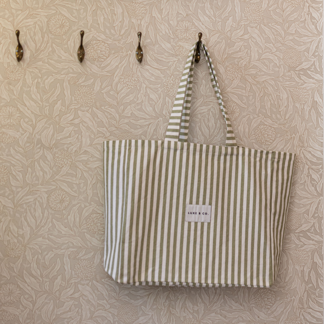 Green striped tote bag by Luxe B Co with sturdy handles and spacious interior, perfect for everyday use.