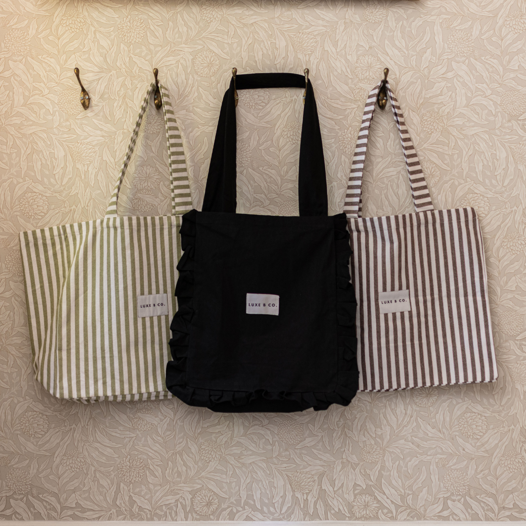 Green striped tote bag by Luxe B Co with sturdy handles and spacious interior, perfect for everyday use and casual outings.