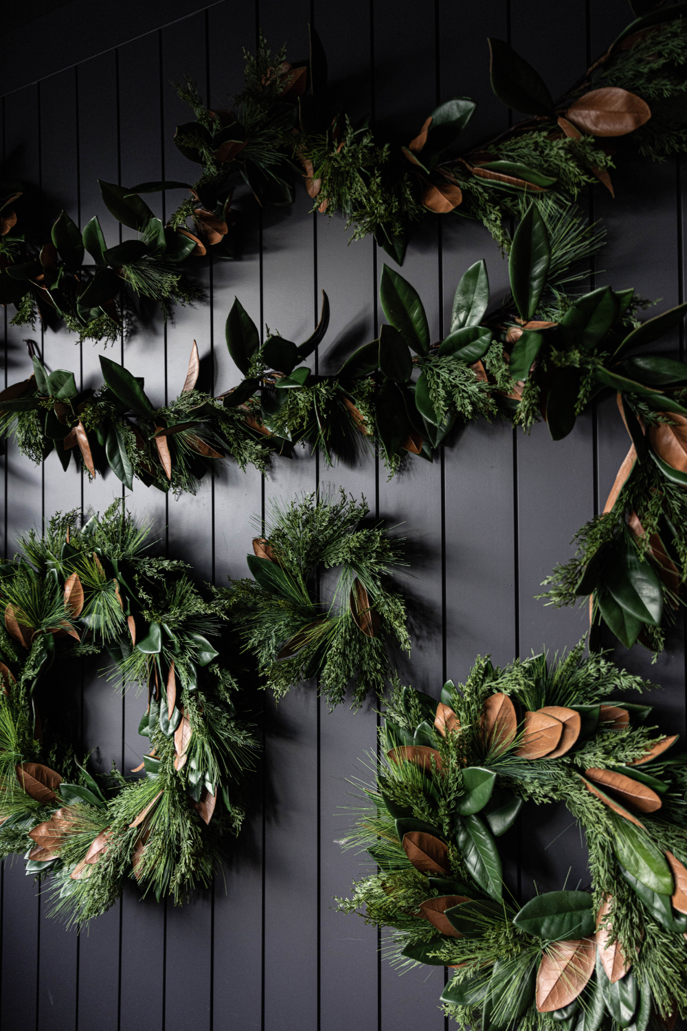 15-foot Magnolia Norfolk Cypress mixed real touch Christmas garland by Luxe B Co with lush greenery and festive foliage.