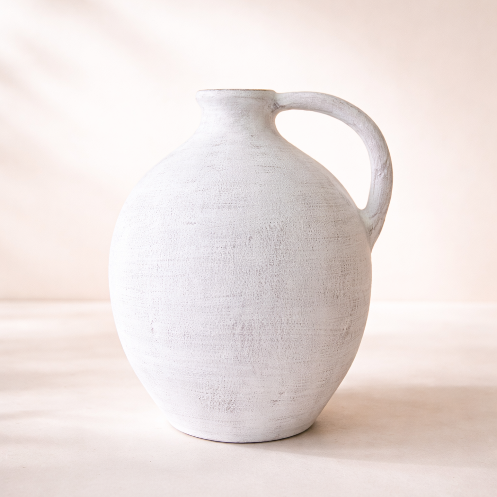 White ceramic pitcher on a light beige background