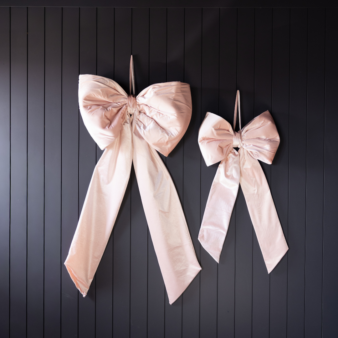 Large light pink velvet bow from Luxe B Co, featuring soft fabric and oversized design, perfect for hair accessories or decorative use.